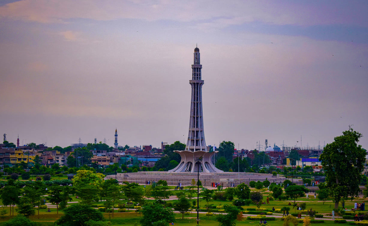 Minar-e-Pakistan, an iconic monument in Lahore, surrounded by lush greenery and symbolizing the historic Lahore Resolution of 1940.