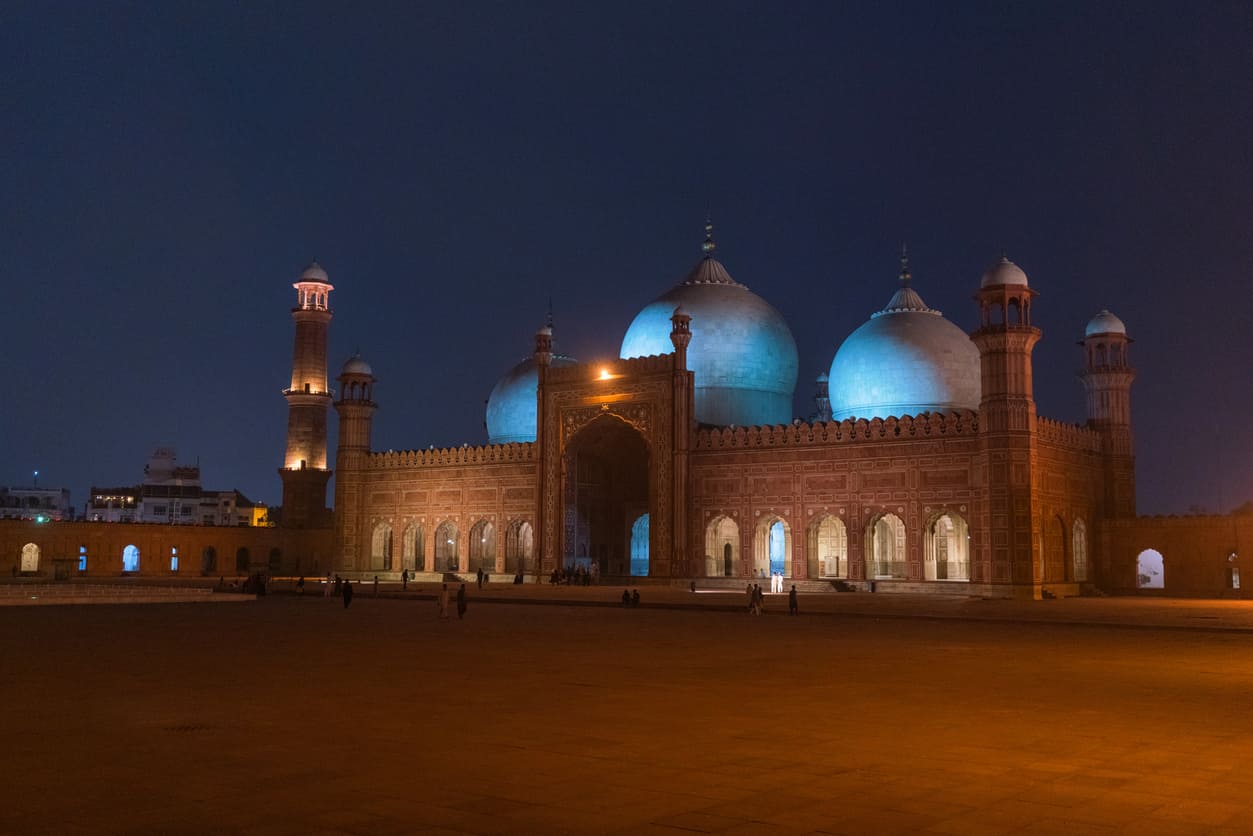 Majestic Badshahi Mosque in Lahore, beautifully lit at night, symbolizing peace and spirituality.