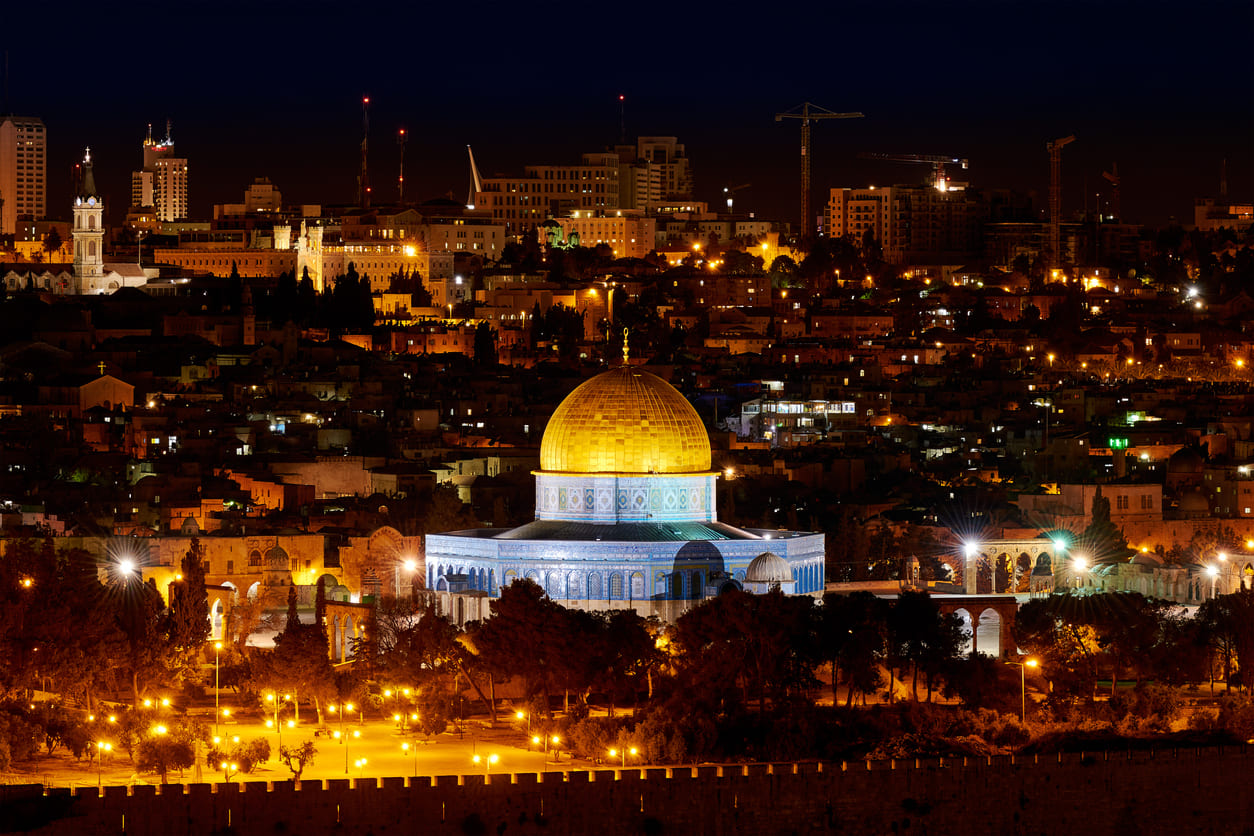 Illuminated Dome of the Rock in Jerusalem, a significant site linked to the Prophet Muhammad's night journey during Shab-e-Meraj.