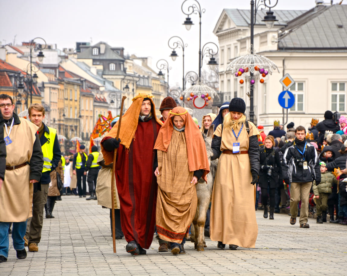 A lively Epiphany procession in Poland, featuring people dressed in biblical costumes as part of the Three Kings' Parade celebration.