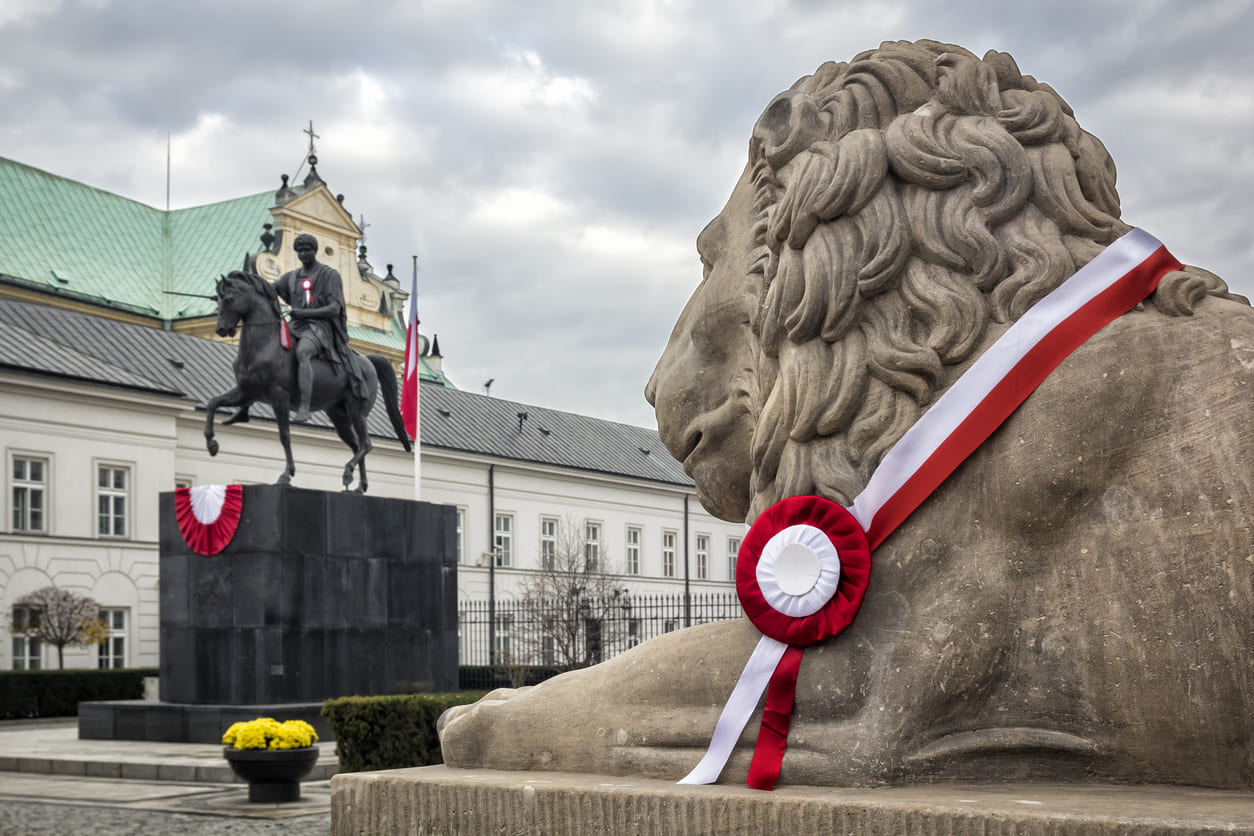 A lion statue with red and white ribbons honors Poland's Independence Day.