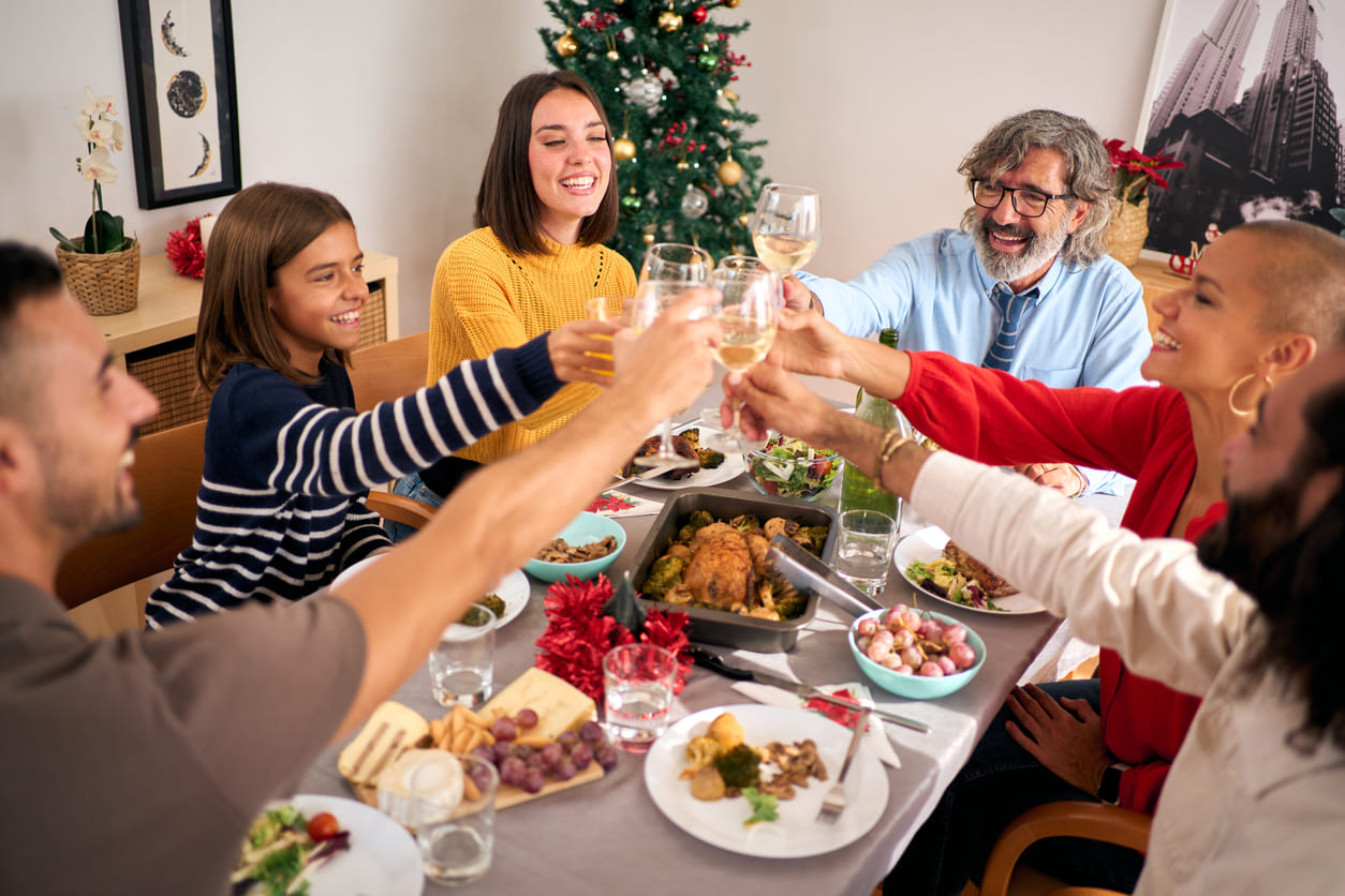 A warm and cheerful Christmas Day gathering, where family and friends share a festive meal, laughter, and a joyful toast.