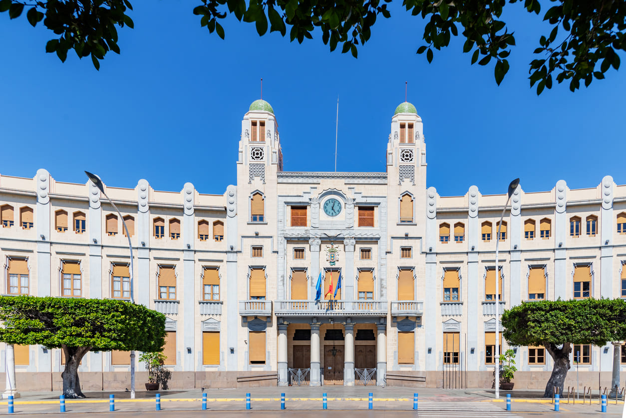 A grand historic building with intricate architectural details, standing in Plaza de España, Melilla, a focal point for official ceremonies and celebrations.