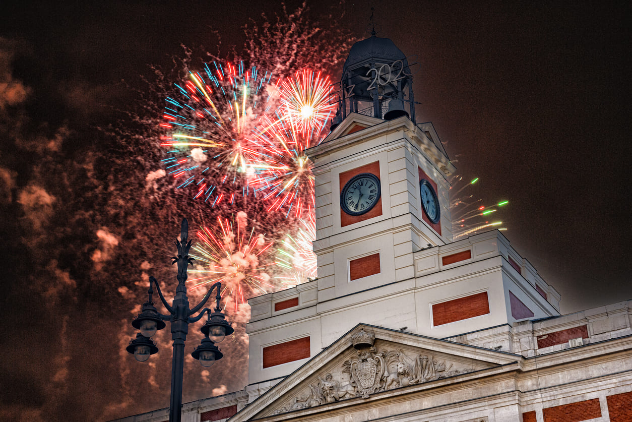 A stunning display of fireworks illuminates Madrid's Puerta del Sol, as the iconic clock marks the arrival of the New Year.