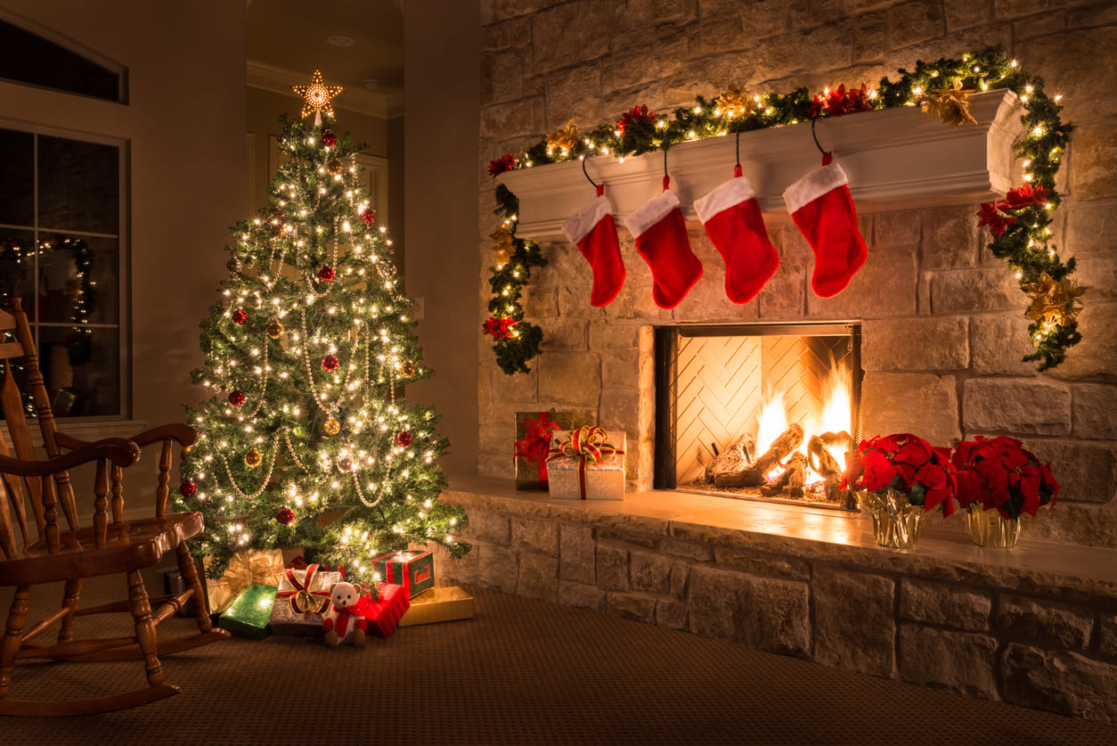 A festive Christmas Eve setting with a decorated tree, stockings by the fireplace, and presents beneath the tree.