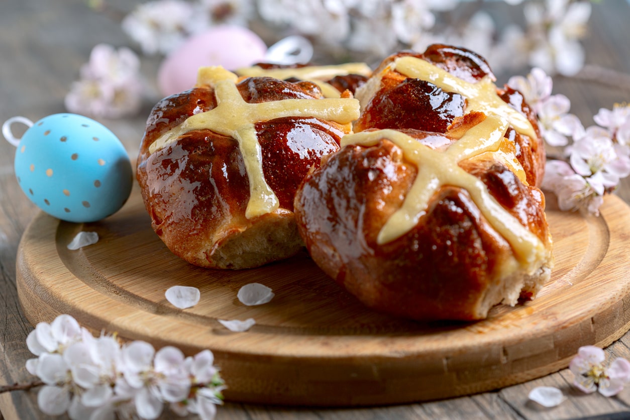 Freshly baked hot cross buns with a cross design, cherished on Good Friday.