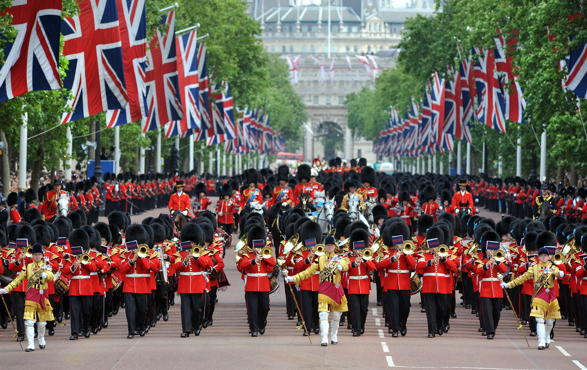 Trooping the Colour parade in London, featuring guards in red uniforms and bearskin hats, honoring the King's Birthday.