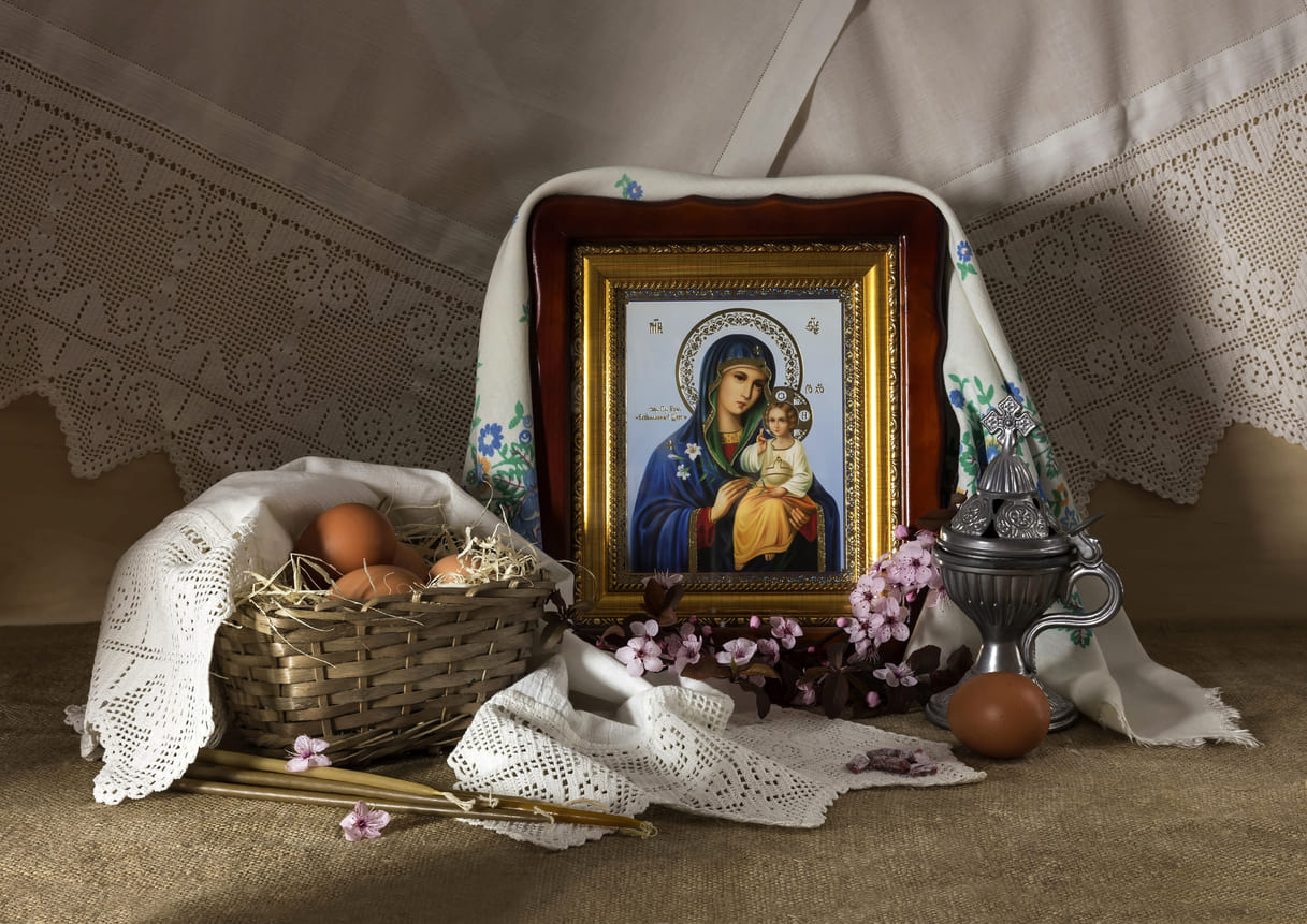 A traditional Orthodox Easter display features the Virgin Mary, beautifully decorated eggs, and ornate cloths, symbolizing faith and renewal.