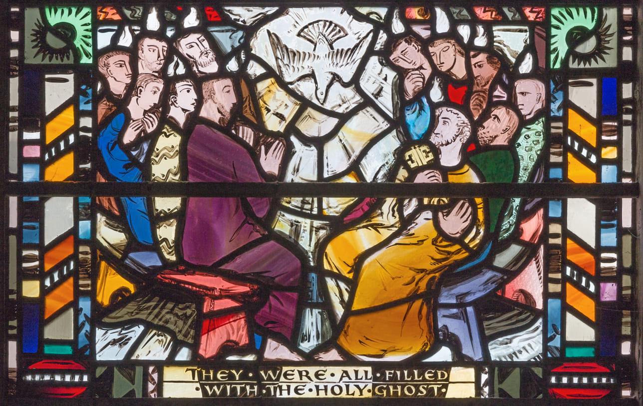 A stained glass artwork depicts the apostles receiving the Holy Spirit, shown as tongues of fire and a descending dove.