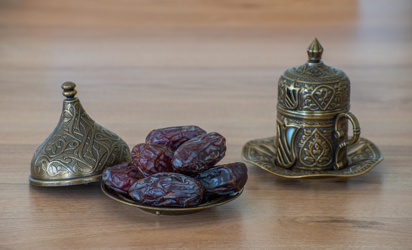 Traditional setup with dates and an ornate cup, symbolizing the breaking of the fast during Ramadan