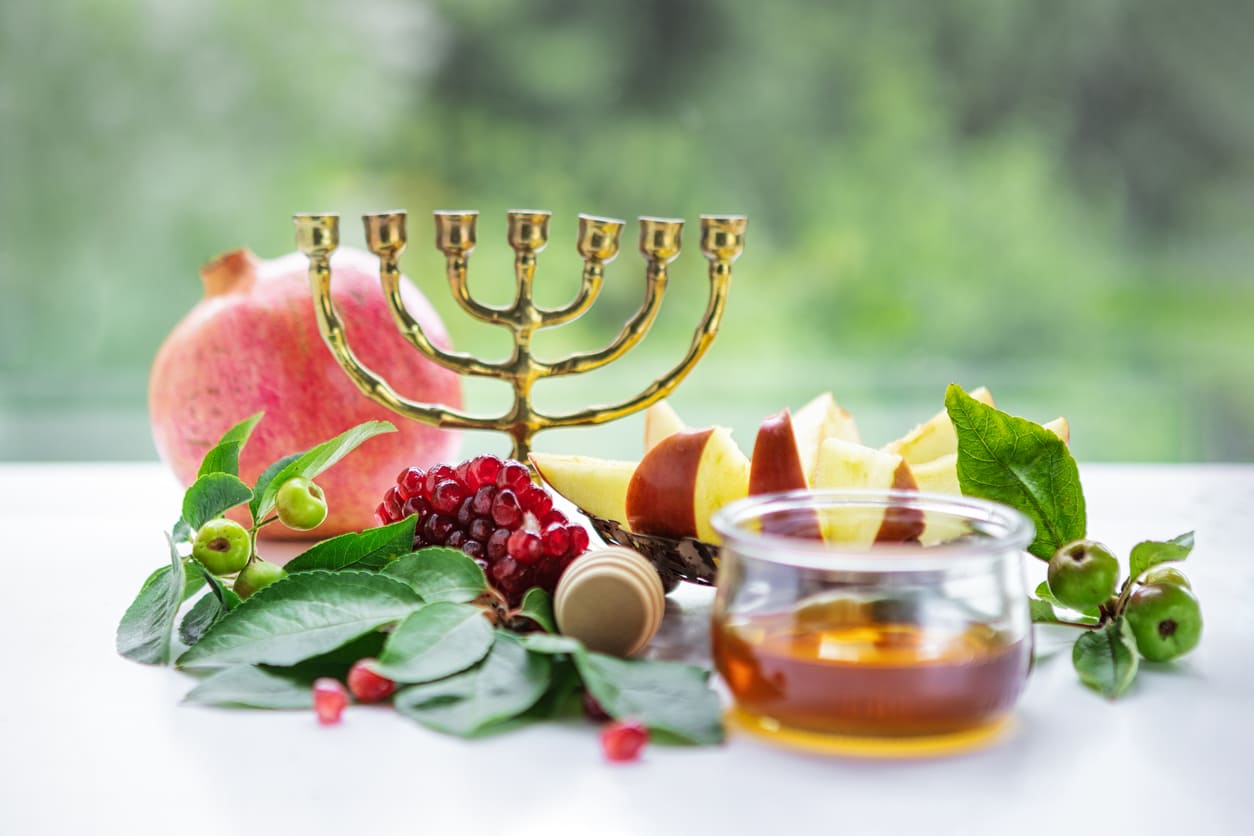 A selection of symbolic foods for Rosh Hashanah, representing hopes for a sweet and prosperous new year.