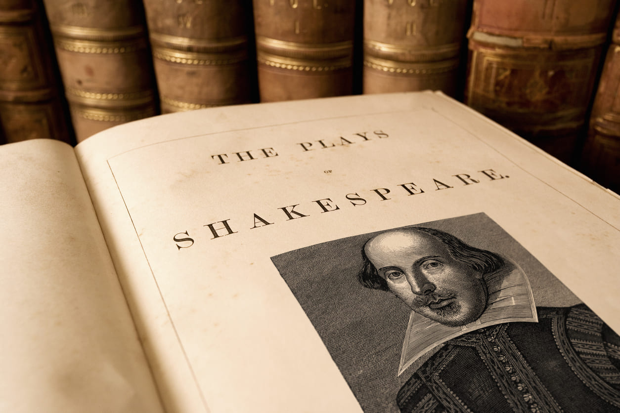 A collection of Shakespeare's plays with his portrait, celebrating his legacy on Shakespeare Day.