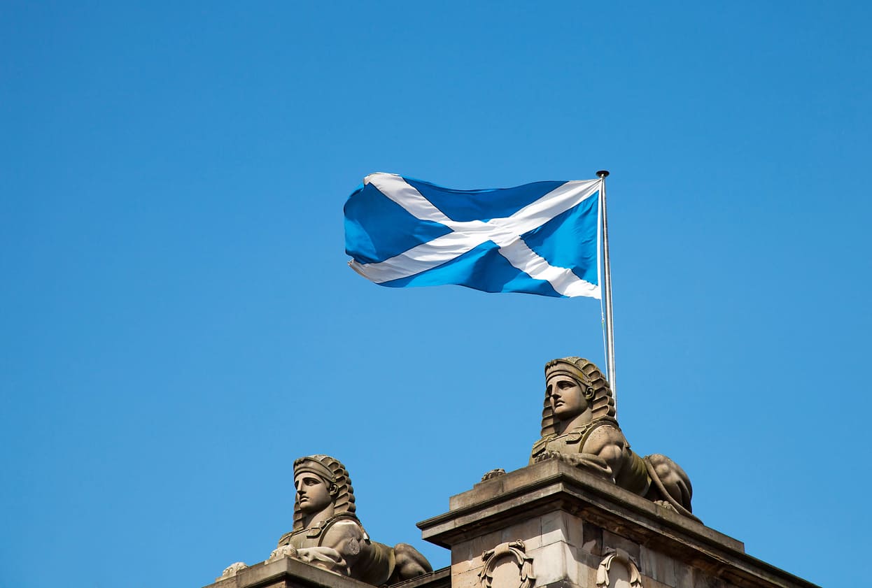 Scottish Saltire flying atop a building, symbolizing Scotland's heritage and pride, often highlighted during St Andrew's Day celebrations.