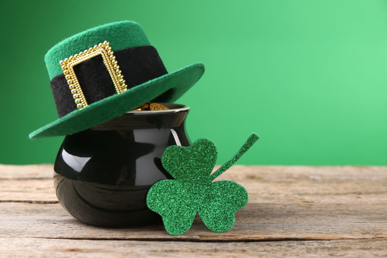 St. Patrick's Day celebration featuring a leprechaun hat, a pot of gold, and a glittery shamrock.