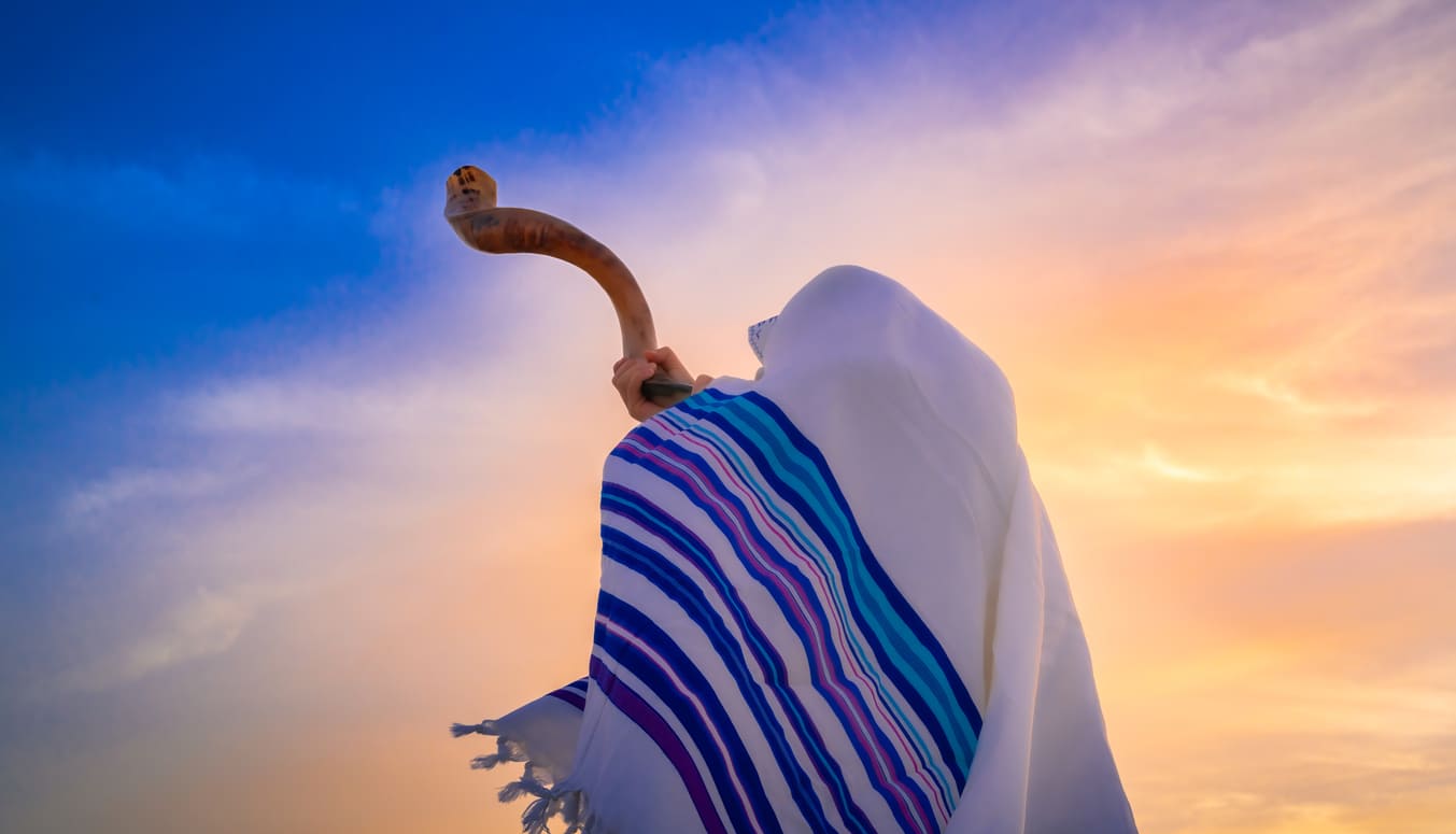 A Jewish person blows the shofar, marking the end of Yom Kippur, the holiest day in the Jewish calendar.