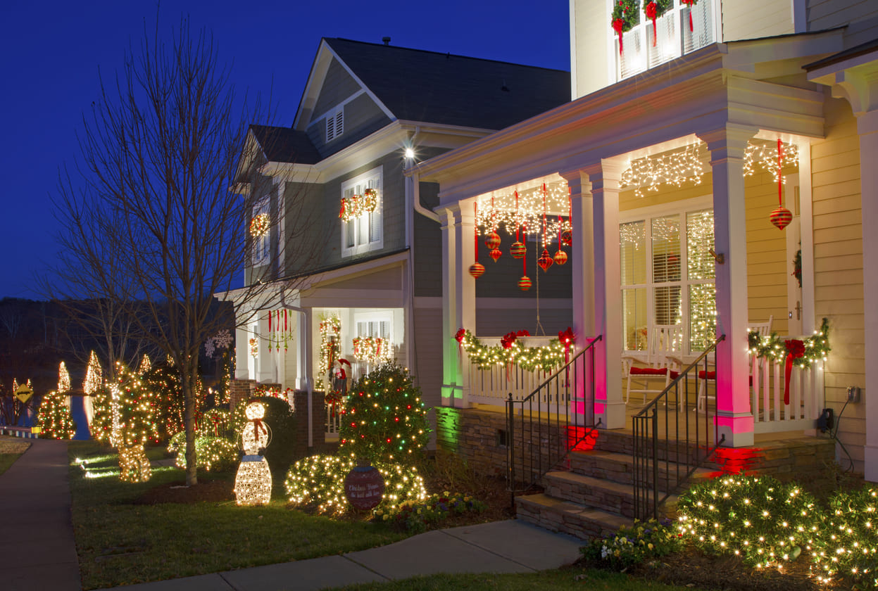 A beautifully decorated house glows with Christmas lights and ornaments, extending the holiday cheer into the night.