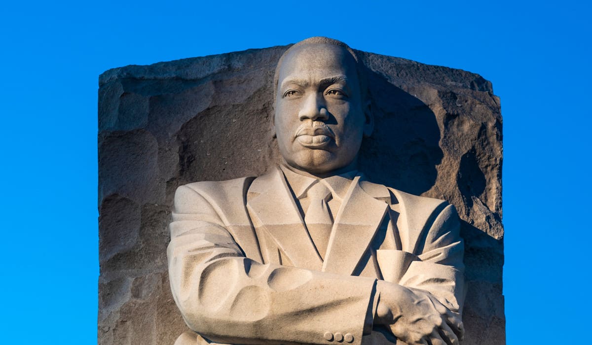 A stone sculpture of Martin Luther King Jr. stands prominently, symbolizing his enduring legacy of justice and equality.