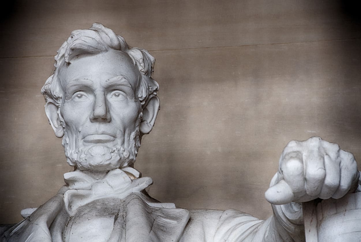 A close-up view of the Lincoln Memorial statue captures Abraham Lincoln's solemn expression, symbolizing his enduring legacy.