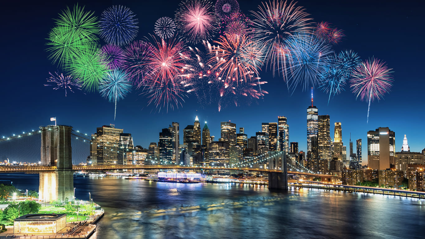 Fireworks burst over the Manhattan skyline in New York, creating a spectacular celebration above the city.