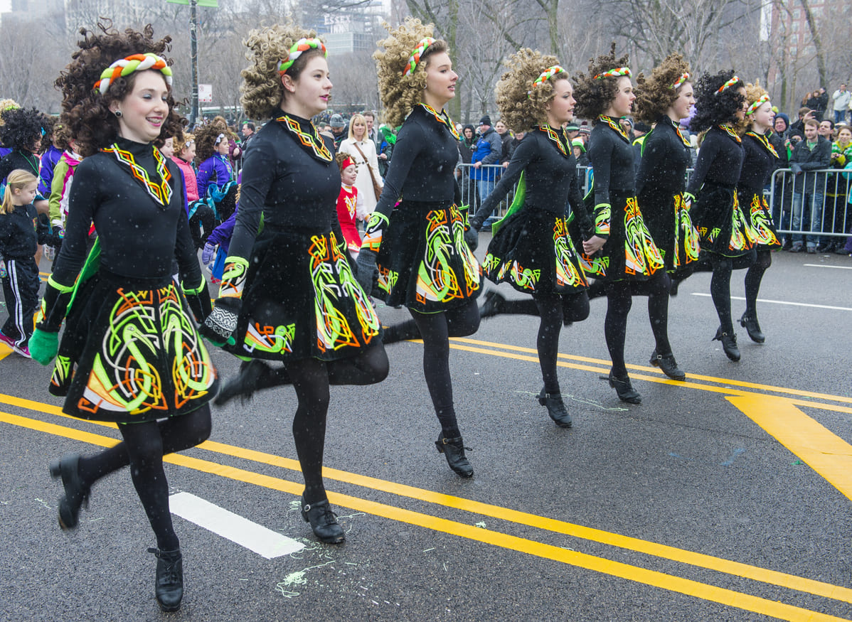 Irish dancers in colorful traditional attire perform during Chicago's annual St. Patrick's Day Parade, celebrating Irish heritage.